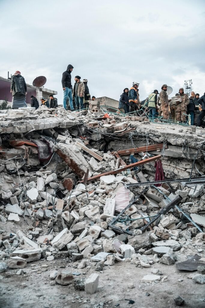 People inspect rubble after an earthquake in Jindires, Aleppo Governorate, Syria.