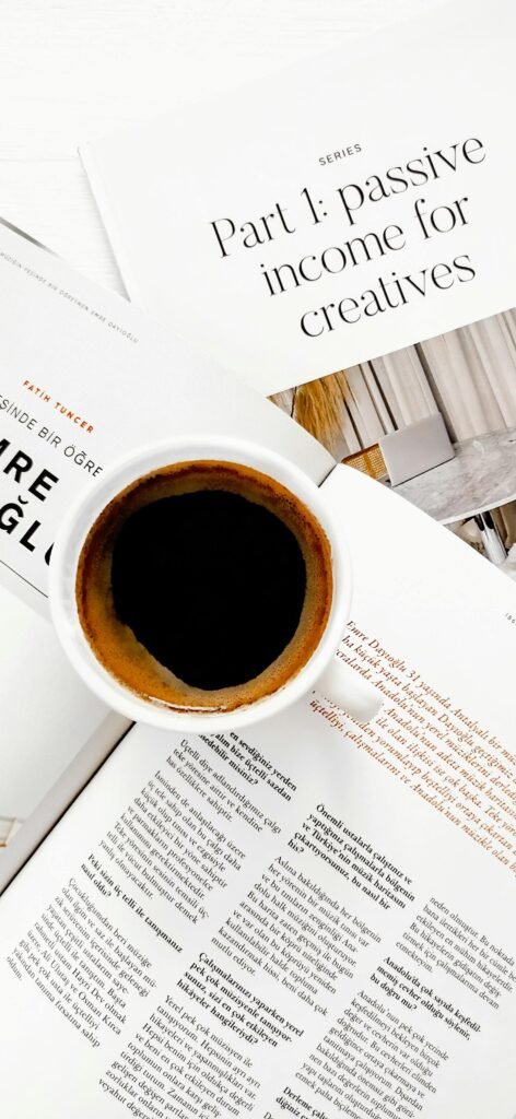 Cup of coffee on papers about passive income, perfect for creative work environments.